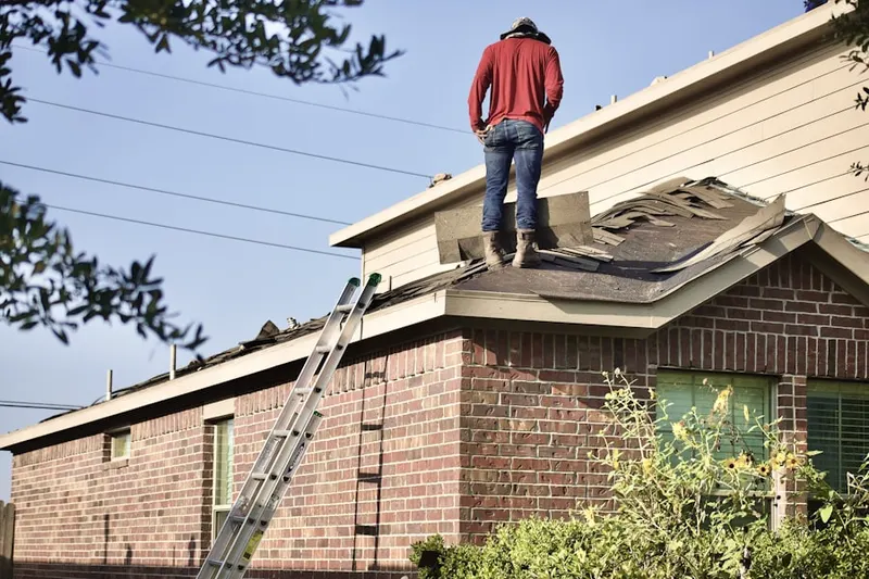 Professional roofer working on a residential roof in River Forest